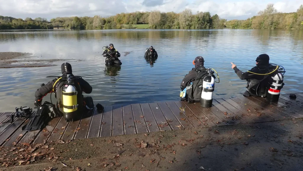 Scuba divers at a lake